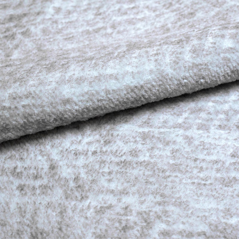 Faux fur fabric with a herringbone type pattern on it